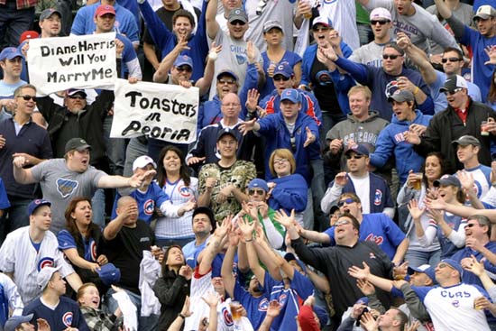 Fans scramble to grab the home run ball just hit by Aramis Ramirez